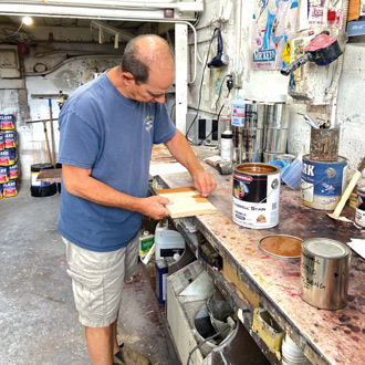 Andy Clark of Clark Paint Factory mixing custom stain